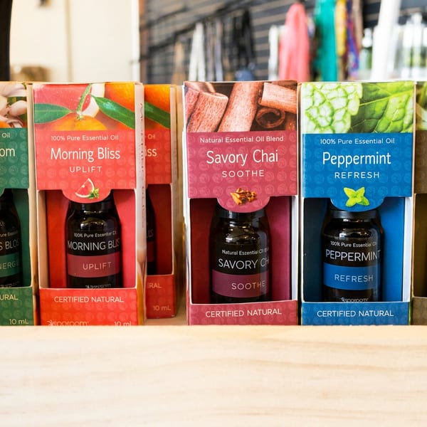 Five Sparoom essential oil bottles in colorful packaging, including Citrus Blossom, Morning Bliss, Savory Chai, Peppermint, and Lemongrass.